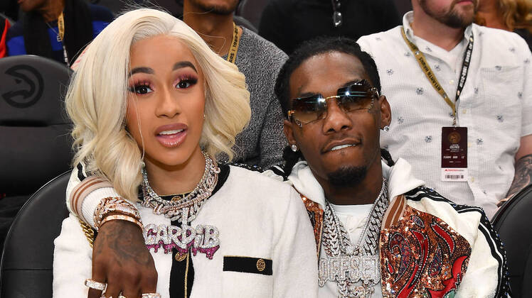 Cardi B, with blonde hair and a white shirt next to Offset, also wearing white