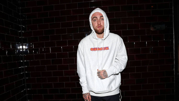 Mac Miller wearing a white sweatshirt