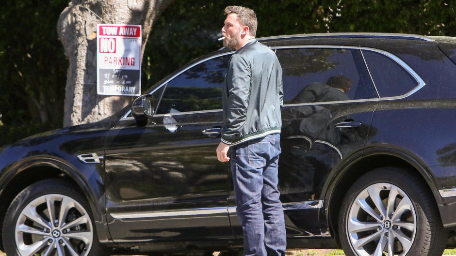 Ben Affleck smoking near a car