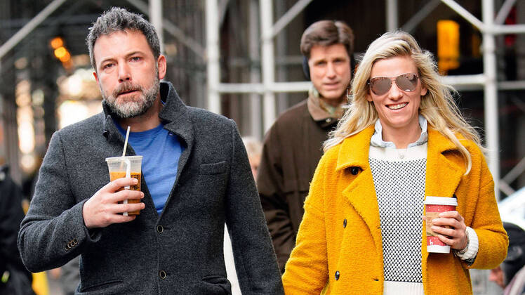 Ben Affleck holding hands with Lindsay Shookus in a yellow coat