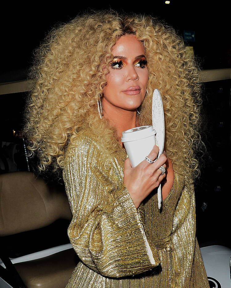 khloe kardashian wearing a gold dress