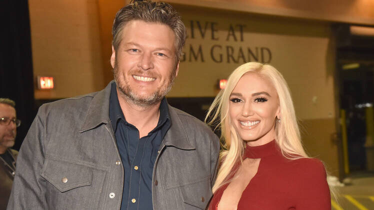 Blake Shelton Wearing a Jacket and Gwen Stefani Wearing a Red Dress