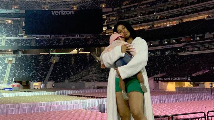 Cardi B on Stage Holding Her Daughter Kulture