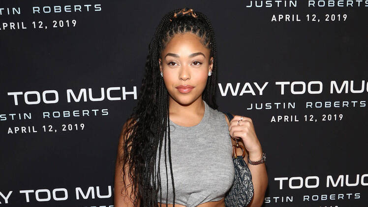 Jordyn Woods Wearing a Gray Dress With Her Purse