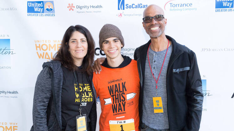 Cameron Boyce Wearing an Orange Shirt With His Family