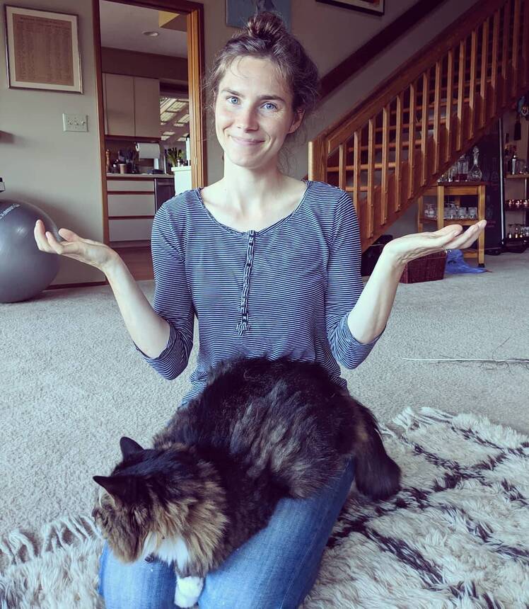 Amanda Knox Shrugs with Cat in Lap