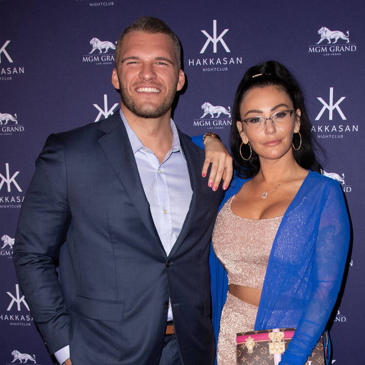 jersey shore star jenni jwoww farley wears a nude two piece outfit under a blue sweater and her exboyfriend zack carpinello wears a light blue button down shirt with a navy blue suit jwoww exboyfriend zack apology