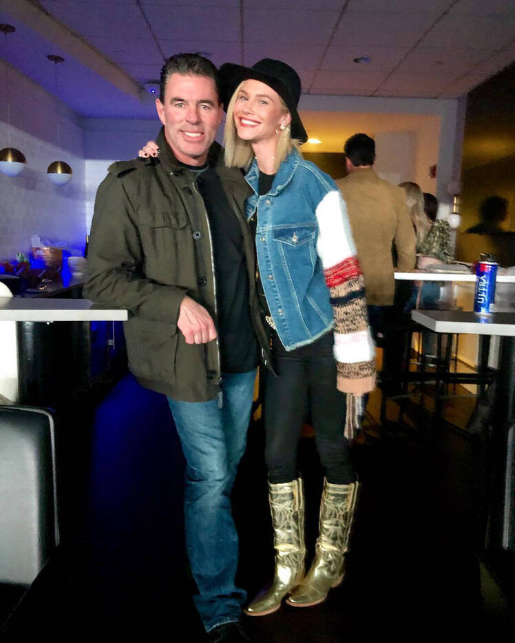 meghan king edmonds wears a denim jacket with patchwork sleeves with black jeans and boots while jim edmonds wears black shirt army green jacket and jeans