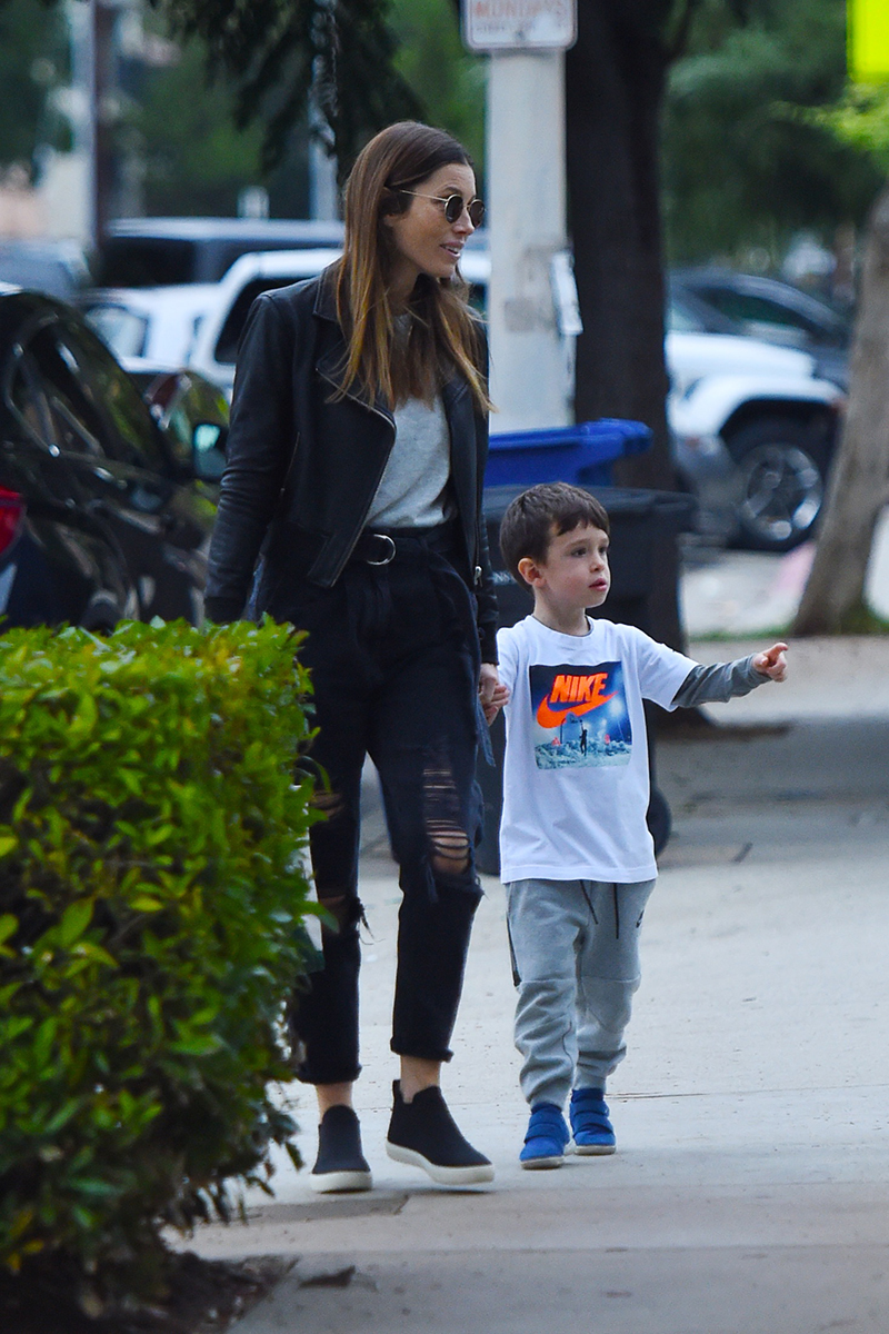 Justin Timberlake cradles son Silas as he and Jessica Biel board