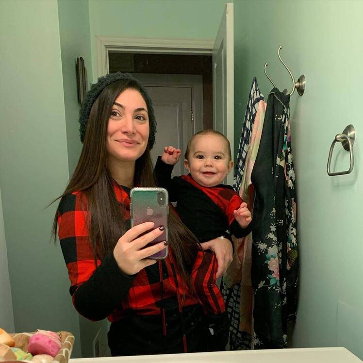 Deena Cortese Wearing a Plaid Shirt Holding Son CJ