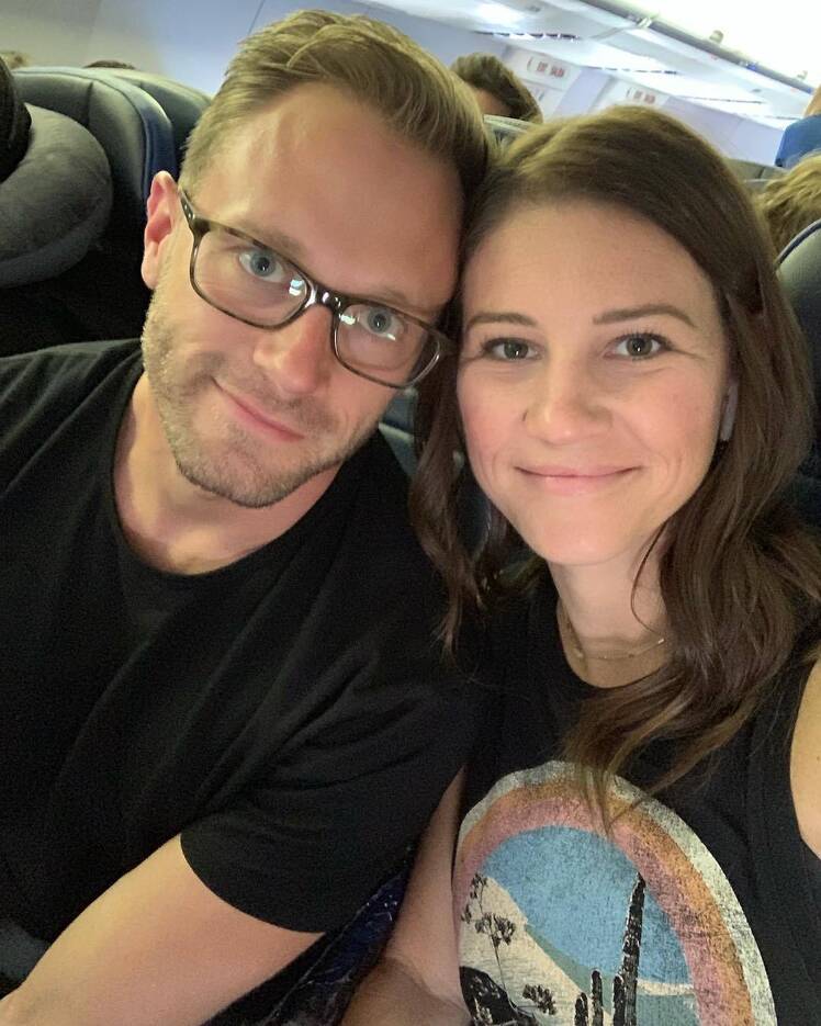 adam and danielle busby sitting on a plane