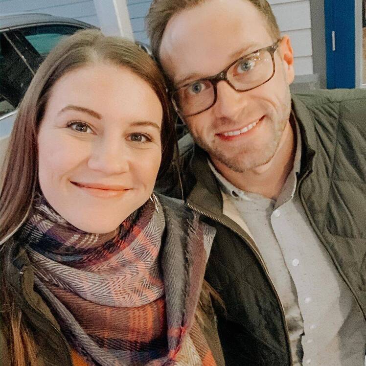 danielle and adam busby smiling on date night