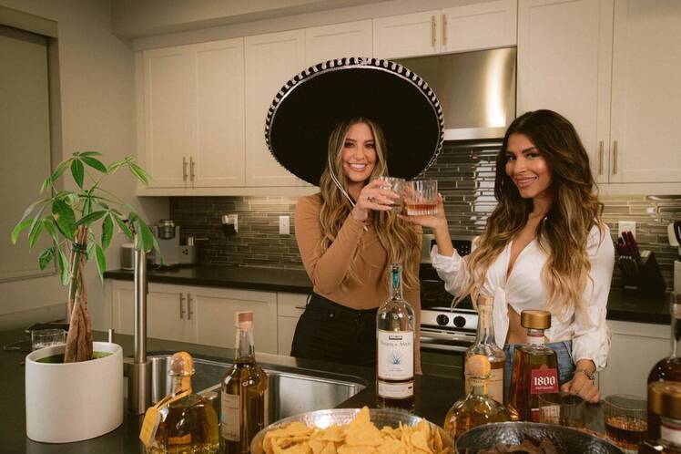 Two Girls Holding Tequila