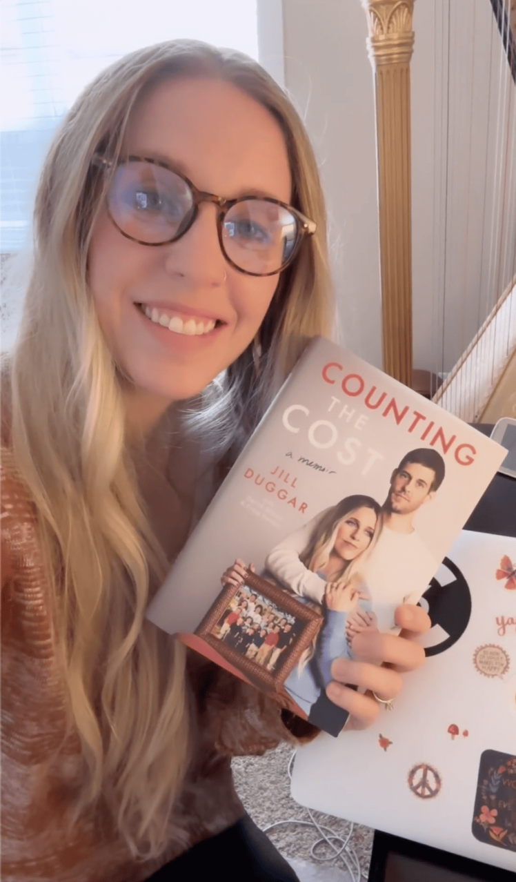 Jill Duggar holding her book Counting the Cost