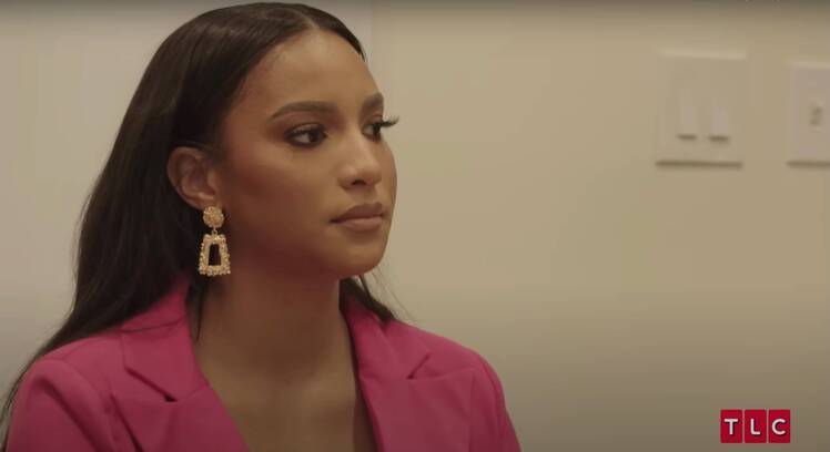 Chantel Everett from The Family Chantel in a shot from season 5 wearing a pink blazer and gold earrings.