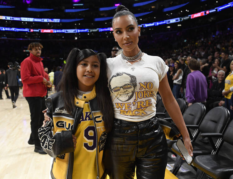 Kim Kardashian and North West pose at the NBA Playoffs