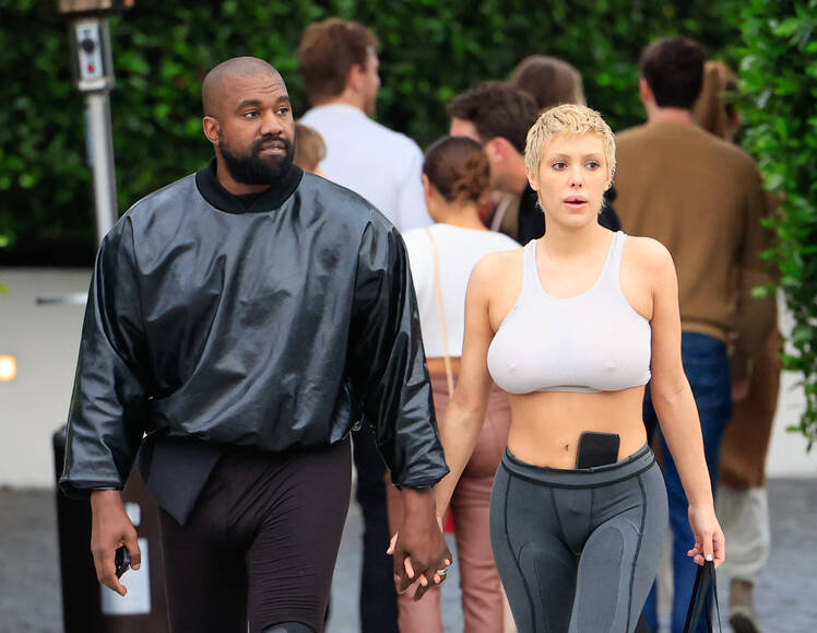 Bianca Censori holds hands while walking with Kanye West.