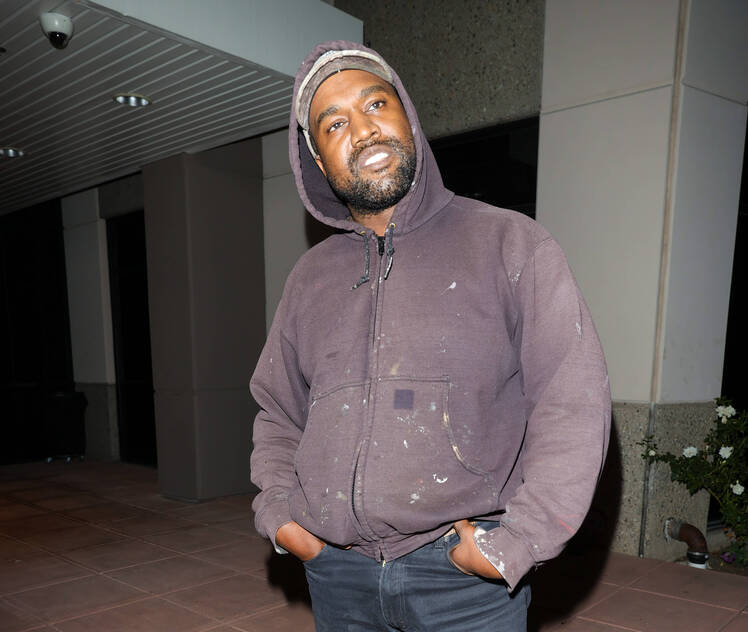 Kanye West seen in Los Angeles wearing a zip up hoodie