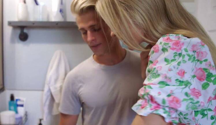 Micah Plath stands with mystery girlfriend in bathroom