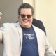Josh Gad waves to cameras outside San Diego Comic Con.